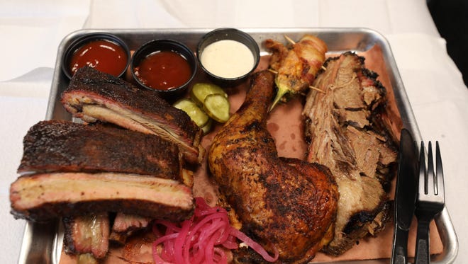 A sample platter at Reilly's Rib Cage in Bergenfield. Clockwise from far left, Ribs, Wiskey Pickles, Stuffed Jalapeno, Brisket, Smoked Bell and Evans Chicken and House Pickled Onions.