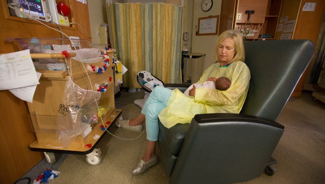 Lisa Heath cares for a baby in the neonatal ICU at Norton Children’s Hospital.  The baby was suffering from neonatal abstinance syndrome. July 5, 2017.