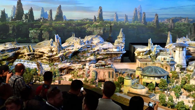 Members of the media get their first look at a 50-foot, detailed model of "Star Wars" land during a media preview for Disney's D23 Expo in Anaheim on Thursday.