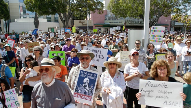 People turn out in San Luis Obispo, Calif., on Saturday, June 30, 2018, to protest the U.S. government's immigration, family separation and child detention policy.