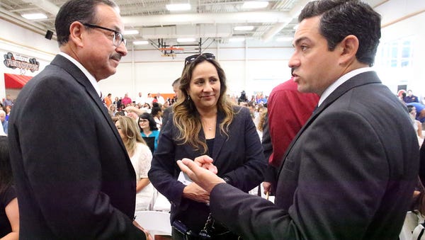 County Commissioner Carlos Leon, left, Judge Angie