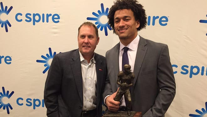 Ole Miss tight end Evan Engram and head coach Hugh Freeze pose with the C Spire Conerly Trophy on Tuesday night in Clarksdale. Engram received the trophy for his performance in his 2016 season with the Rebels.