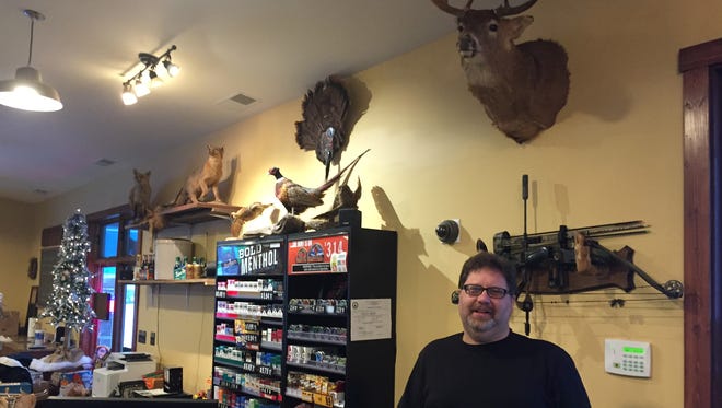 Mike Harbert shows off some of the hunting mounts people have dropped off at his family's business, the Unadilla Store. The original store was destroyed in a January 2015 fire, which also destroyed a collection of local memorabilia. A crossbow behind Harbert is signed by musician Ted Nugent.