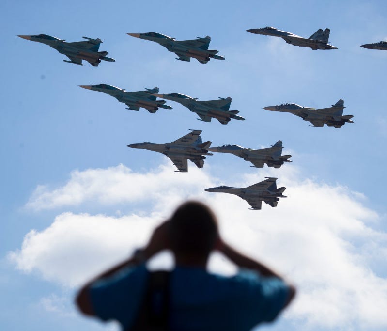 A man watches Russian military jets performing in Alabino, outside Moscow, on Aug. 12.