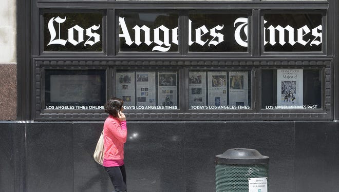A woman walks by the Los Angeles Times building on April 25, 2016.