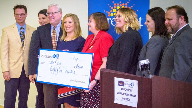 Excellus BlueCross BlueShield presented an $86,490 grant to CareFirst on Wednesday. From left are Assemblyman Christopher Friend, Kara Grippen from the governor's office, state Sen. Tom O'Mara, Excellus Regional President Jessica Renner, CareFirst Treasurer Pam Bliss, CareFirst Director of Development and Public Relations Mary Mosteller, Alison Hunt from U.S. Rep. Tom Reed's office, and Assemblyman Phil Palmesano.