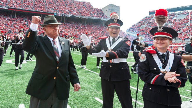 Former Ohio State football coach Earle Bruce dots this "i" in Script Ohio before a 2016 home game with Rutgers.