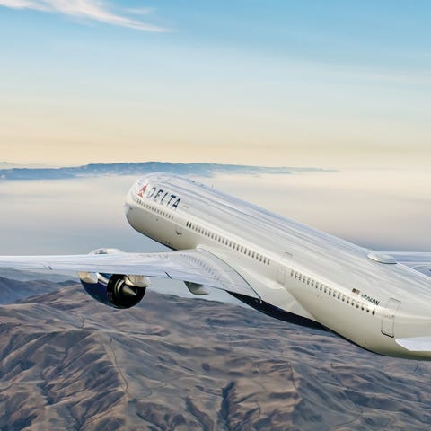 A Delta Air Lines Airbus A350 flying over mountain