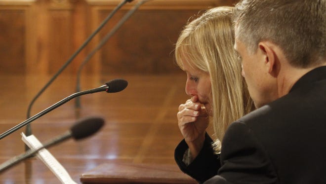 Tears fall as Rep. Cindy Gamrat reads a statement of apology to the state House in a rare disciplinary hearing September 8, 2015, at the State Capitol.  Seated next to her is her attorney Michael Nichols.