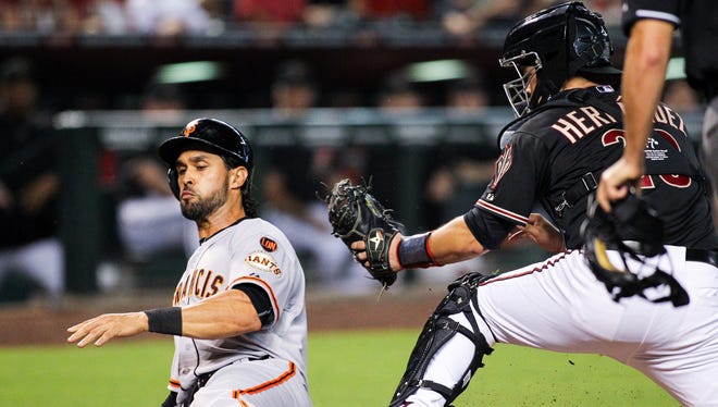 San Francisco Giants center fielder Angel Pagan (16) slides to beat the tag by Arizona Diamondbacks catcher Oscar Hernandez (23) for the second run in the third inning for the Giants at Chase Field in Phoenix, AZ, on Saturday, July 18, 2015.