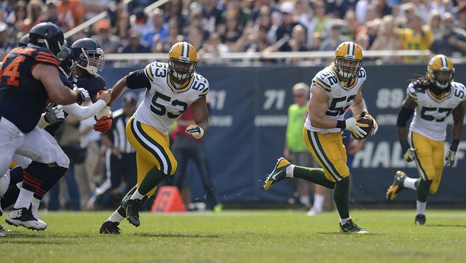 Green Bay Packers linebacker Clay Matthews (52) runs with the ball after making an interception off a tipped ball in the third quarter during Sunday's game against the Chicago Bears at Soldier Field in Chicago.