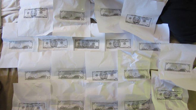 A Florida couple claimed they were converting $1 bill into $50 bills to help pay their rent and support a heroin habit, police said.