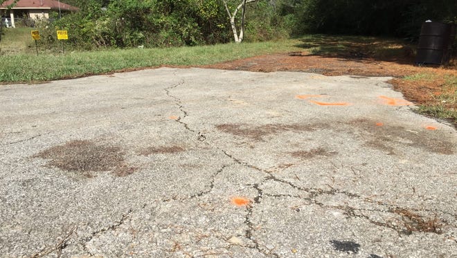 This Wednesday, Nov. 4, 2015 image shows orange paint marking the spot where a 6-year-old boy was shot and killed Tuesday night by Ward 2 city marshals in Marksville, La. The marshals had been chasing a vehicle driven by the boy’s father, Chris Few. He was shot in the head, but survived. He later was taken to Rapides Regional Medical Center in Alexandria for surgery. The boy, Jeremy David Mardis, died at the scene after suffering multiple gunshot wounds to the head and torso. (Melissa Gregory/The Daily Town Talk via AP)