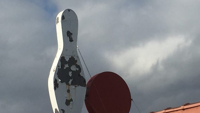 A weathered bowling pin looms over the former Baker Lanes in Cherry Hill.