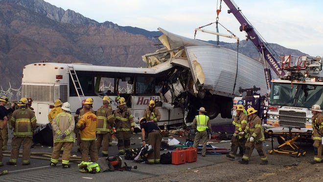 Emergency personnel work to remove victims from a tour bus crash that has killed at least 11 people in Palm Springs early Sunday. The crash occurred just after 5 a.m. along westbound Interstate 10. About 30 others have been hospitalized. A portion of I-10 has been shut down.