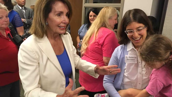 House Minority Leader Nancy Pelosi (left) talks with Rebecca Bernstein, a family practice physician from Milwaukee, Saturday at a campaign event for U.S. Rep. Gwen Moore.