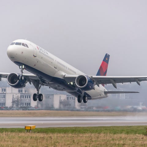 A Delta jet landing at an airport.