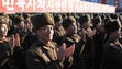 North Korean military personnel celebrate after North