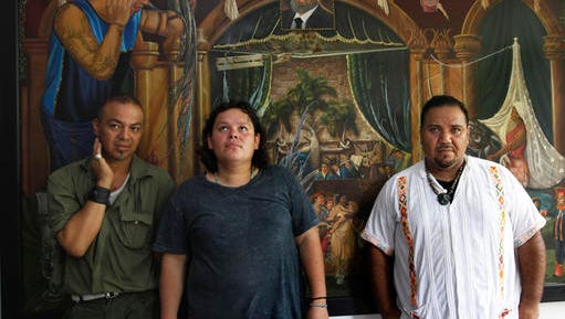 In this July 2, 2016 photo, Luis Edgardo Charnichart Ortega, left, Evanibaldo Larraga Galvan, center, and Juan Carlos Soni Bulos stand in Soni's terrace at his home, in Tanquian de Escobedo, San Luis Potosi, Mexico. The three men were detained by Mexican Marines, tortured and spent more than a year in prison on weapons and drug charges, without trial until a judge in March 2015 threw out the case.