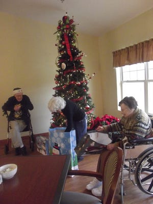 Friday was the Christmas Social at Anna’s Healthcare assisted living center in Sturgeon Bay. Staff members each picked a resident as their Secret Santa, and Santa Claus himself distributed the gifts. From left, Lee Graf, Jean Callan and Eleanor Olesen open presents.