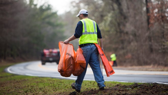 Inmates on the Anderson County Sheriff's Office litter crew work to clean up the trash on the side of Liberty Highway on Wednesday, February 8, 2017 in Anderson.
