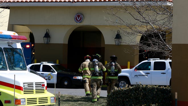 Firefighters with the Farmington Fire Department enter the Red Lion Hotel on Thursday. The hotel was briefly evacuated after a woman's body was found in one of the rooms.