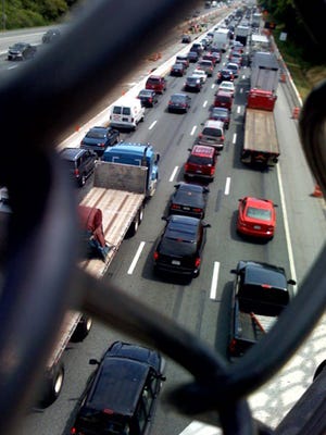 Traffic on I-95 is seen from the fenced bridge along Churchman Road  following an accident.