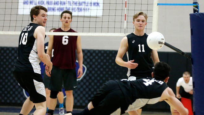 Boulder Creek Liam Santa Cruz, #4, dives for a ball hit by Perry during the high school boys volleyball, Division I state championship game at Mesquite High in Gilbert on May 14, 2016.