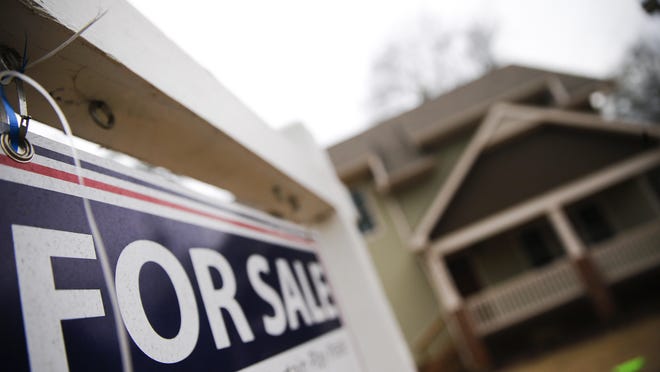 In this Tuesday, Jan. 26, 2016, photo, a "For Sale" sign hangs in front of an existing home in Atlanta. On Thursday, Feb. 11, 2016, Freddie Mac reports on the weeks average U.S. mortgage rates. (AP Photo/John Bazemore)