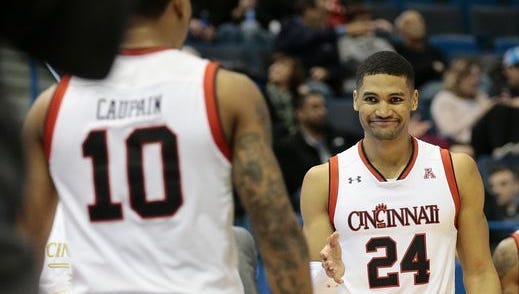 University of Cincinnati junior forward Kyle Washington shares a moment with teammate Troy Caupain during Friday's 80-61 win over Tulsa. Washington led UC with 21 points.