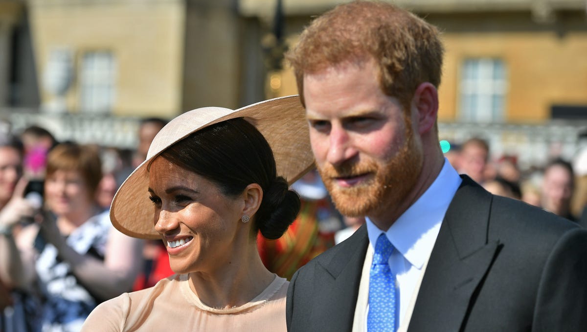 Prince Harry Duke of Sussex and his bride, Duchess Meghan of Sussex at a garden party at Buckingham Palace on May 22, 2018, in their first royal engagement as a married couple.