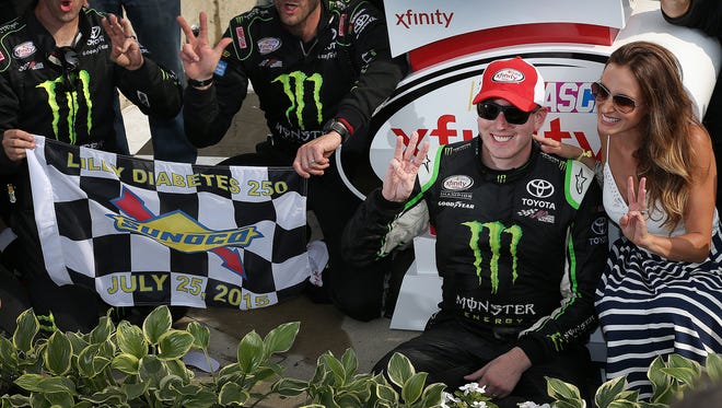 Kyle Busch celebrates winning the 4th Annual Lily Diabetes 250 Xfinity series race Saturday, July 25, 2015, afternoon at the Indianapolis Motor Speedway. His wife Samantha Busch,right, and crew members on the left.