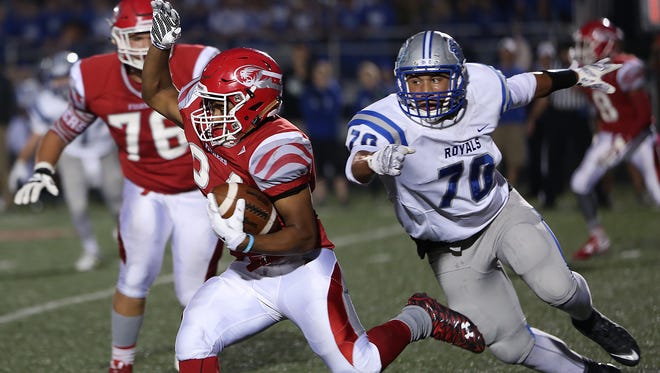 Fishers #24 Jermaine Huddleston runs for yards as HSE #70 Collin Miller comes from behind in first half action during the high school football sectionals Round 1 game of Hamilton Southeastern at Fishers, Friday, October 23, 2015.  Fishers leads 24-7 at the half.