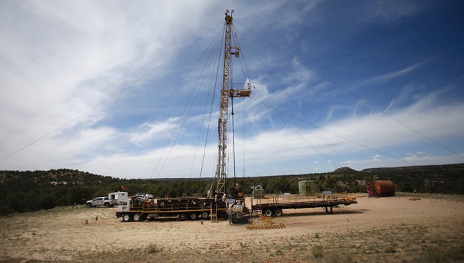 A work over rig stands on April 10, 2015, at a natural gas well site in San Juan County.