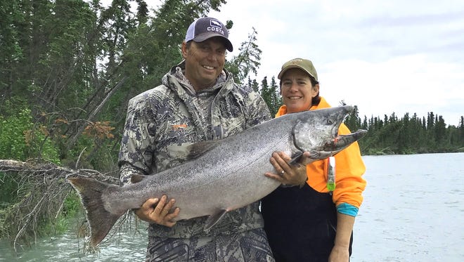 Dave Jacobs, left, and Christine Rinaldi of Austin, Texas pose with a huge 49.5-pound Kenai River king salmon that was caught this week in Alaska while getting ready for this weekend's big Sacramento River salmon fishing opener.