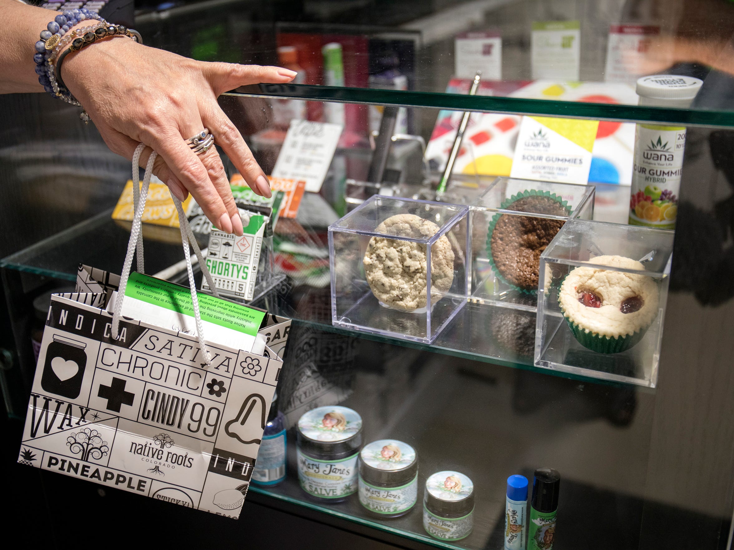 A customer chats with a budtender about various edibles