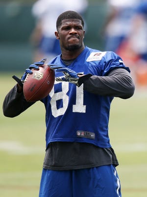 Wide receiver Andre Johnson (81) prepares to deliver a pass during practice at the Indianapolis Colts' training facility in Indianapolis, Ind., Tuesday, June 9, 2015.