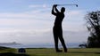 Tiger Woods plays his shot from the third tee during