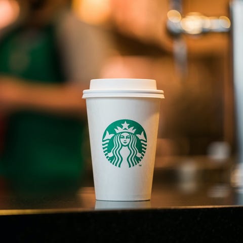 A Starbucks coffee cup, with the company's green l