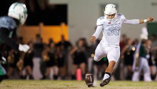 Naples High School's Jerry Nunez kicks off  against Fort Myers on Friday (11/20/15) in the Region 6A-3 semifinals at Edison Stadium in Fort Myers. Naples beat Fort Myers 37-26.