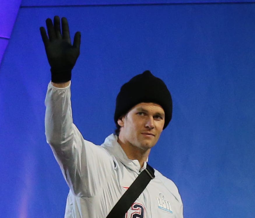 Patriots quarterback Tom Brady waves to the fans as he takes the stage during Super Bowl LII Opening Night at Xcel Energy Center.