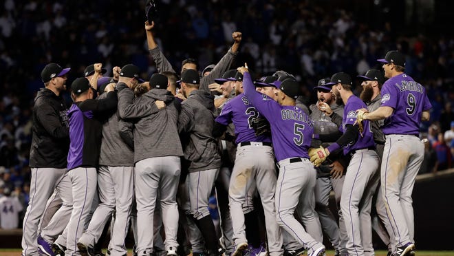 Colorado Rockies players celebrate after the Rockies defeated the Chicago Cubs 2-1 in the National League wild-card playoff baseball game Tuesday, Oct. 2, 2018, in Chicago. (AP Photo/Nam Y. Huh)