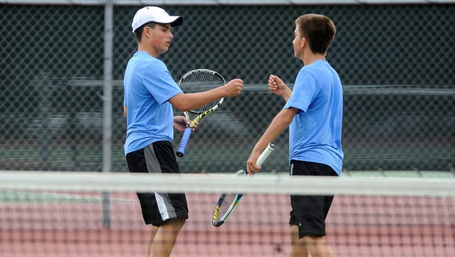 Lincoln's Sam Dobbs plays doubles with his brother, Kaleb, against Washington's Nate Ackert and Elliot Hartwig during boys state tennis at McKannen Park in Sioux Falls, S.D., Saturday, May 23, 2015. 