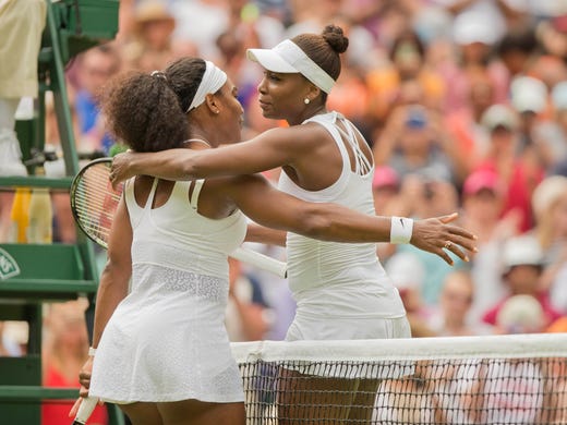 Serena and Venus hug at the net after their match on