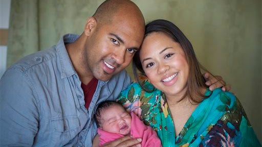 This image released by Boneau/Bryan-Brown shows actor Josh Tower, left, with his wife Karen Cortes-Tower and their baby Marlow. Josh Tower debuted in "Motown the Musical," and welcomed the birth of his daughter on the same day.