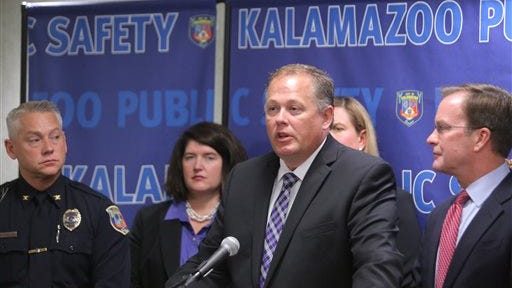 Michigan Attorney Gen. Bill Schuette, center, and Kalamazoo County Prosecutor Jeff Getting, right, join Kalamazoo Public Safety Chief Jeff Hadley, left, at police headquarters in Kalamazoo, Mich.,to announce the arrest of Tennessee truck driver Calvin Ray Kelly, 57, for sexual assault of a Southwest Michigan victim in 2008 rape cold case. He was arrested in Tennessee and will be transported to Michigan after waiving extradition. (AP Photo/Kalamazoo Gazette-MLive Media Group, Mark Bugnaski) ALL LOCAL TELEVISION OUT; LOCAL TELEVISION INTERNET OUT