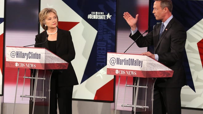 Former Maryland Gov. Martin O'Malley speaks as former Secretary of State Hillary Clinton looks on during the Democratic presidential debate Saturday, Nov. 14, 2015, at Drake University in Des Moines, Iowa.