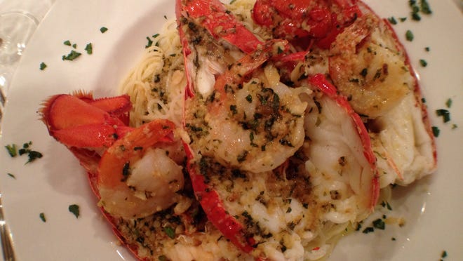 Bill’s Steak and Seafood Restaurant in east Naples specializes in New England seafood, offering entrees such as this steamed lobster dinner featuring three split tails topped with three shrimp scampi on a bed of rice and pasta.