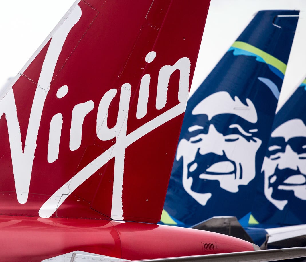 Virgin America and Alaska Airlines tails mingle togther at Seattle-Tacoma International Airport on March 24, 2017.