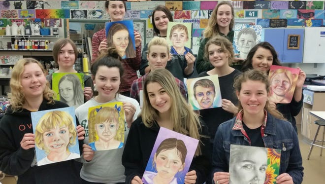 Seneca High school art majors show portraits they drew from photographs of orphans in Ukraine they have never met. The art was done for the Memory Project, a nonprofit that connects youth internationally through art and sends the portraits to the Ukrainian children.